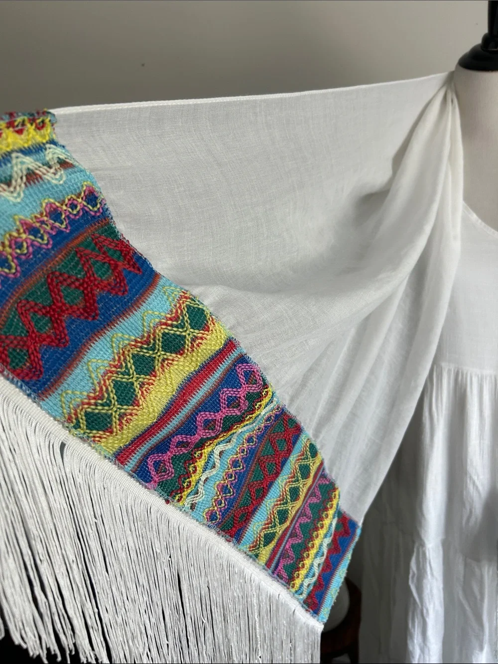 World Market white fringe scarf with red blue yellow green stitching